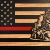 thin red line wood flag with fire firefighter in fire attack position