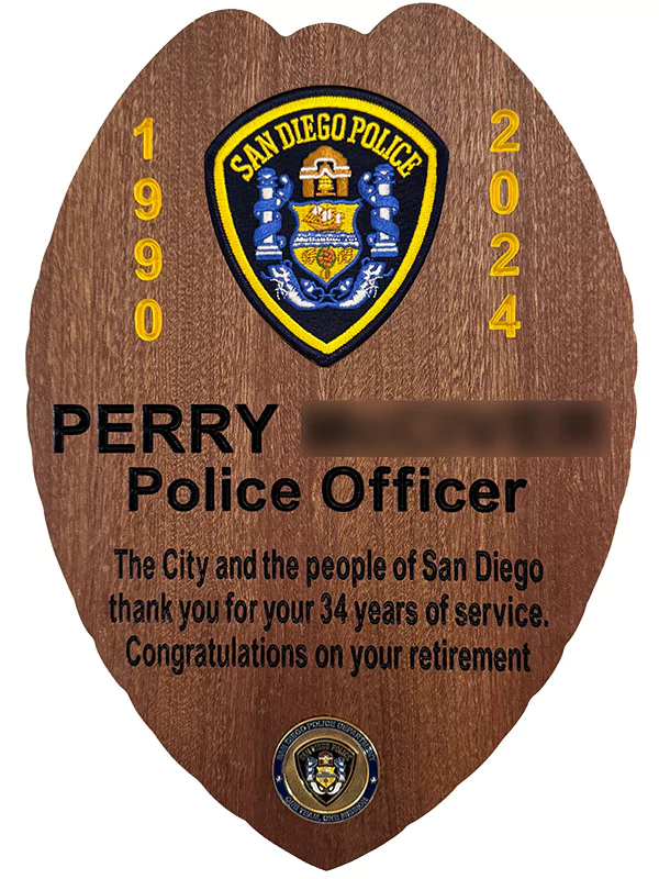 sdpd retirement plaque in the shape of a badge. the plaque includes a recessed sdpd patch.