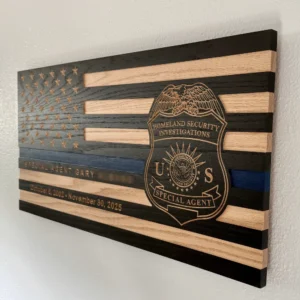 side view of thin blue line wood flag with homeland security investigations (hsi) badge