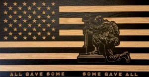 kneeling soldier with fallen soldier battlefield cross wood flag